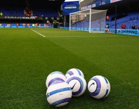 Footballs on pitch